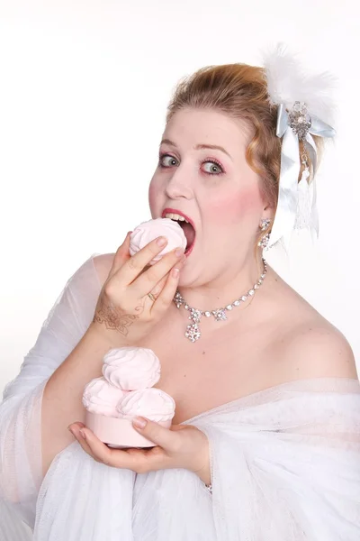 Plus size woman eats sweets with a pleasur — Stock Photo, Image